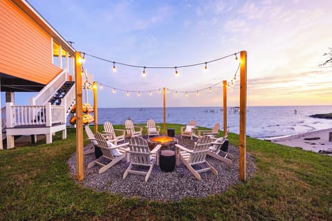 Enjoy sunsets and s'mores from your outdoor fire pit, including 10 Polywood adirdonack chairs, string lights and s'mores starter kit.