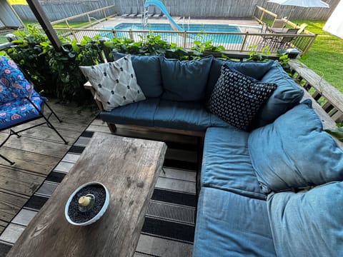 patio with seating  overlooking pool. 