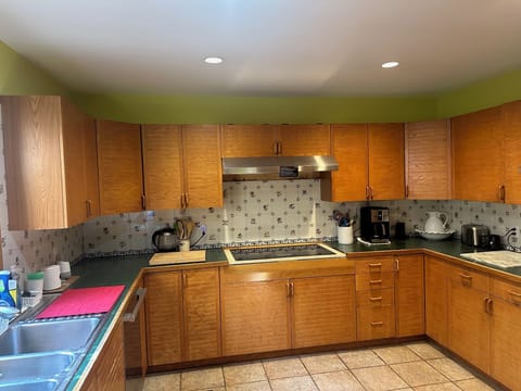 Large roomy kitchen with double sink, double oven, and induction stove