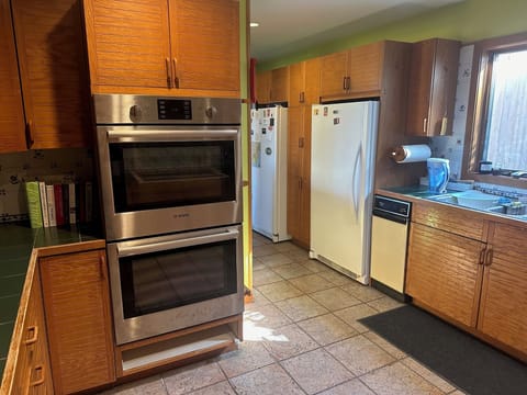 Along with double oven, the kitchen has fridge and freezer 