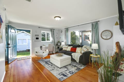 Relaxing bright and spacious living room with comfy sofa, seating and Smart TV