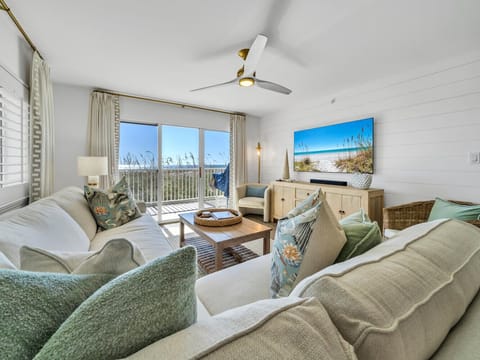 Sink into plush coastal-themed seating while gulf breezes flow through your private balcony doors, creating the perfect retreat.