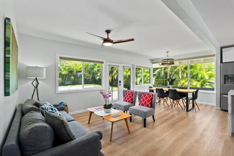 Bright and airy, this open-plan living space seamlessly connects the lounge area to the dining room, highlighted by natural light and stylish furnishings.