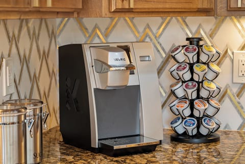 Keurig with an assortment of k cups as well as a traditional coffee pot