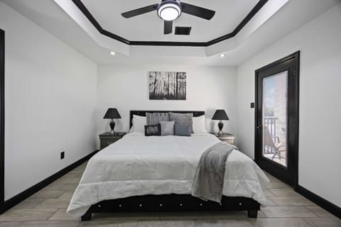 Primary bedroom features King size bed, covered patio, and full bathroom.