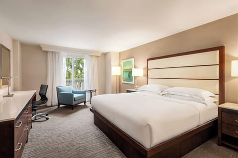 Unwind in a sunlit king room with calming views.