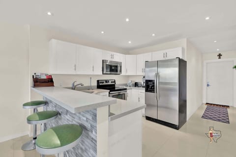 There’s a convenient breakfast bar with three bar stools for a quick snack