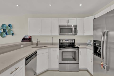 A sleek and spacious kitchen and shiny stainless steel appliances so you can prepare meals at home
