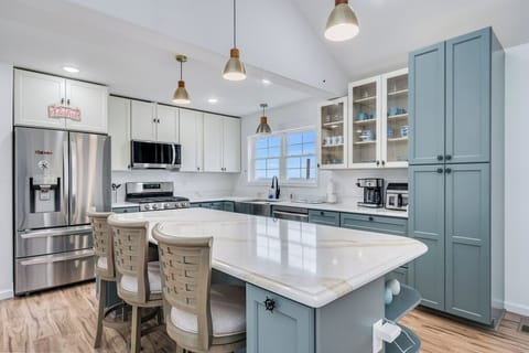 Chef's Kitchen with Quartz Countertops and Stainless Appliances.