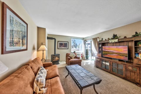 Settle into this cozy living room where warm leather seating and a crackling fireplace create the perfect retreat after your mountain adventures.