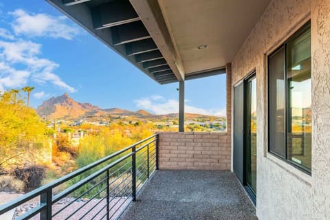 Balcony view of majestic mountains under a clear blue sky