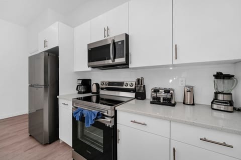 Fully equipped kitchen with modern appliances and ample space for home-cooked meals.