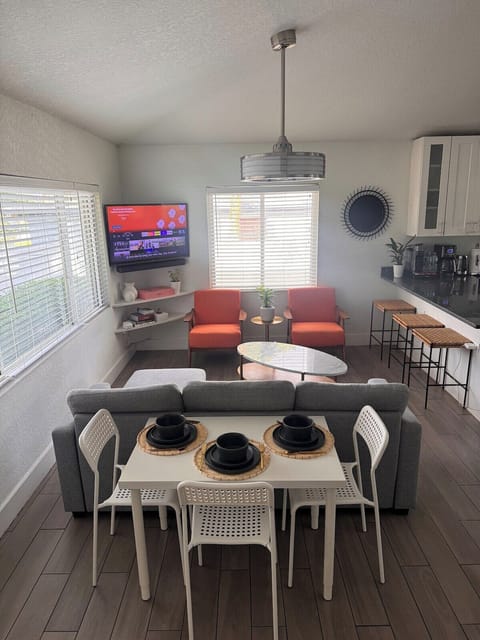Bright and comfortable living room with smart TV, plush seating, and a queen-size sofabed — perfect for relaxing, entertaining, or accommodating extra guests. Ideal for both short and extended stays.