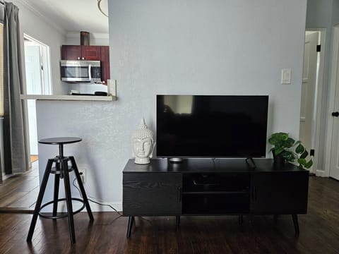 Livingroom with Smart TV and bar seating.