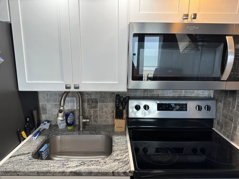 Full stove/oven, sink and full size refrigerator