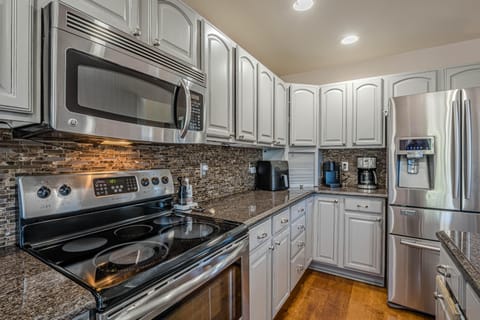 Step into a beautifully designed kitchen, outfitted with gleaming stainless steel appliances that make meal prep a delight.