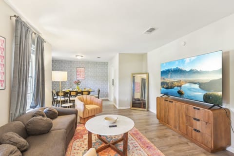 Cozy, vibrant living room to gather with friends and family to watch on the 75"!