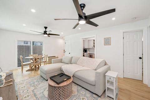 Open plan layout with dining, lounge, and natural light throughout.