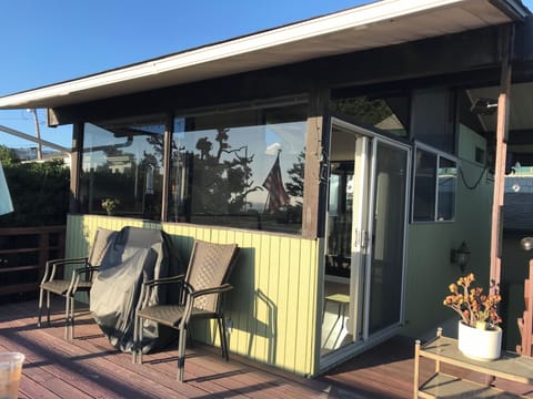 Deck sitting area with a electrical grill.