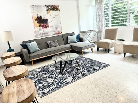 Roomy and well lit living room with plenty of room for all. Also has a TV.