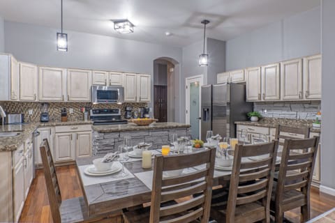 Completely stocked, modern kitchen features table eating for 8.