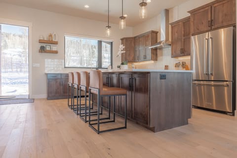 Fully equipped kitchen with modern appliances and elegant gathering island.