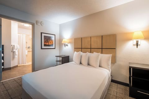 Settle into crisp linens and soft lighting for deep sleep.