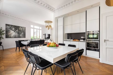 A fully-equipped, modernized kitchen opens onto the living area -American Fridge