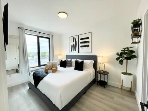 Modern bedroom king bed, memory foam, 55" TV, Roku, blackout curtains city view.