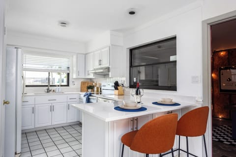 Kitchen with kitchen island and bar seating for 2