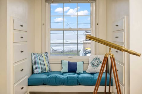 Cozy details like a window seat tucked into an upstairs dormer and TVs in the bedrooms add an extra touch of relaxation and charm.