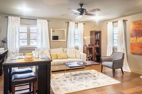 Cozy living room with a modern touch, featuring soft neutral tones, natural light, and a comfortable ambiance for relaxation.