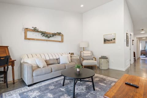 The stylish living room features a chic couch that easily converts into a comfortable bed, adding extra flexibility for your stay.