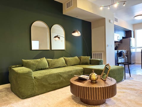Art Deco Style Apartment with a stunning Hollywood hills view Living room with a comfy L-shaped sofa and a 55" Smart TV with (Netflix, Hulu, and Disney+ we logged them remotely) included for free.