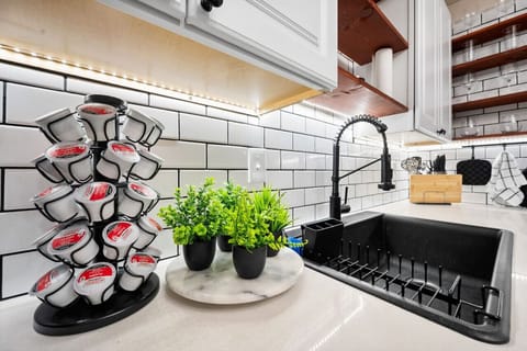 Countertop view of modernized coffee, sink, and prep area