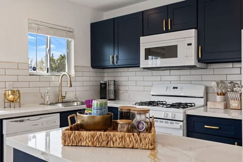 Fully equipped kitchen w/ stainless appliances and ample counter space for easy home cooking.