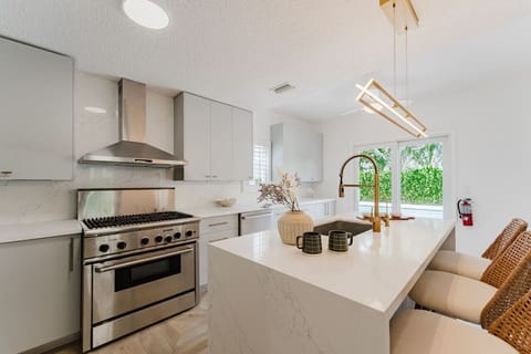 The wide, well-lit sink area enhances functionality, making meal prep and cleanup a breeze. Its bright design keeps the space feeling fresh and inviting.