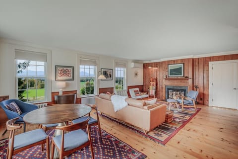 Living room with fireplace (currently out of order) and game table. 