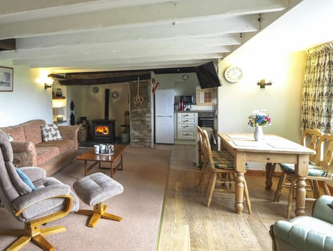 Two seater sofa, lounge chair with foot rest, arm chair, coffee table and log burner. Dining table with four chairs