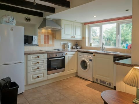 Fitted kitchen units, cooker, washing machine, fridge/freezer, microwave, kettle, sink and window
