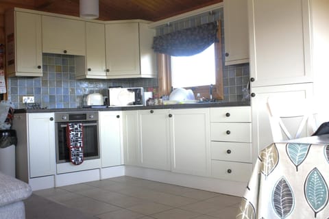 Fitted kitchen with electric cooker, toaster, kettle and microwave