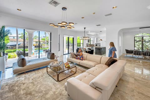 The waterfront family room features a smart TV and access to the heated pool.