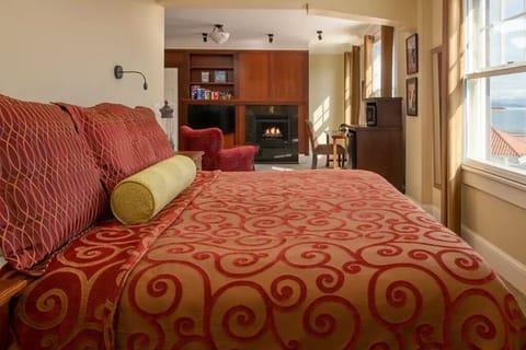 Sink into patterned linens while the fireplace glows nearby.