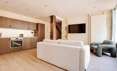 An open-plan kitchen, fully equipped with fridge, freezer, oven, induction hob,
