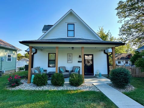 Front of the home. With inviting front porch and comfy furniture.