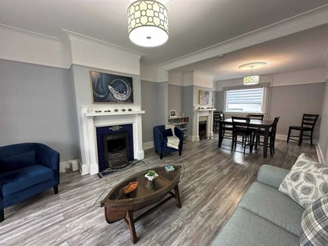 Where comfort meets warmth: a haven by the fireplace. #IndoorFireplace #ComfyCouch