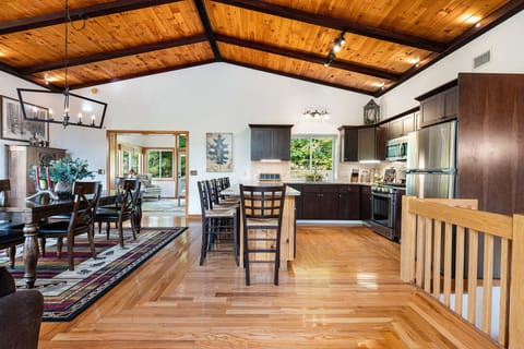 The great room with a shot of the fully equipped kitchen, this was recently renovated and it has updated appliances! The dining area has a large table with 8 chairs