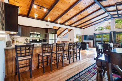 The great room. This room is located on the second floor. There's a fireplace, 65" TV, huge kitchen peninsula, and more! The kitchen is fully equipped