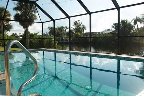 "Take a refreshing dip in your own private screened-in pool, overlooking serene canal views."