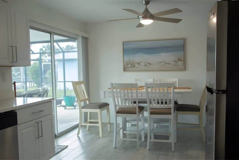 "Enjoy meals with a view in this bright and airy dining space overlooking the pool and canal."